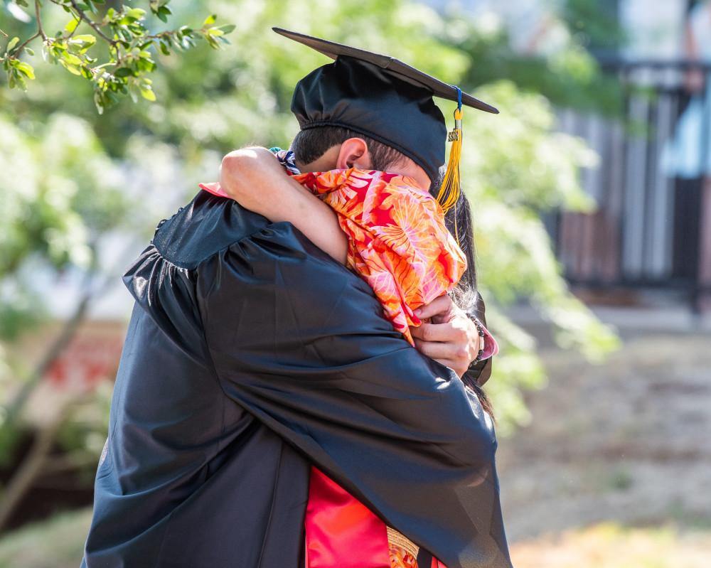 Student hugs family member at the Spring 2022 Graduation ceremony